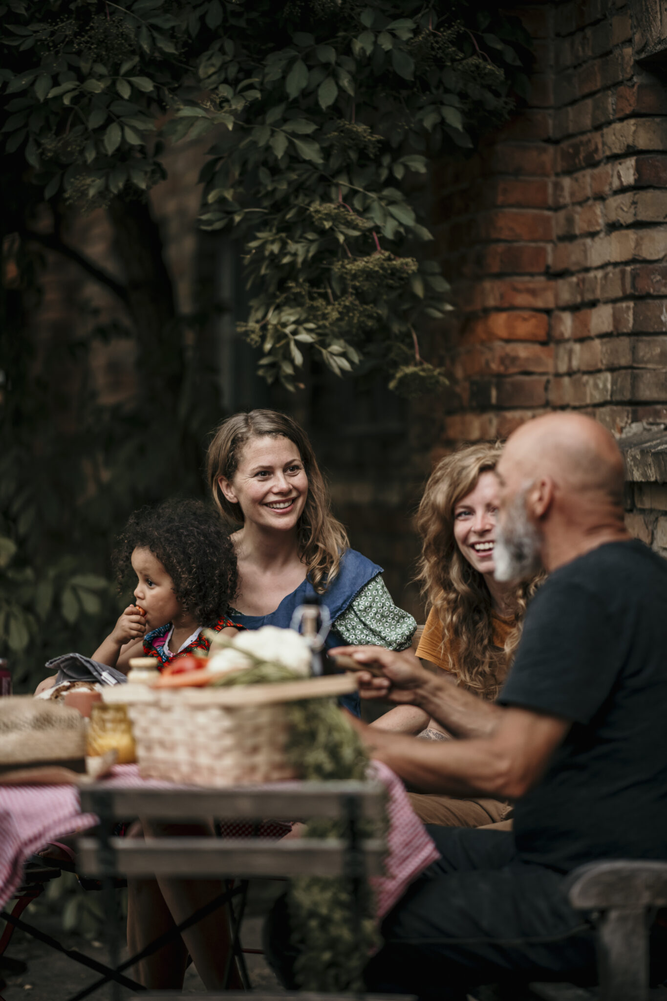 Friends having discussion while sitting at backyard