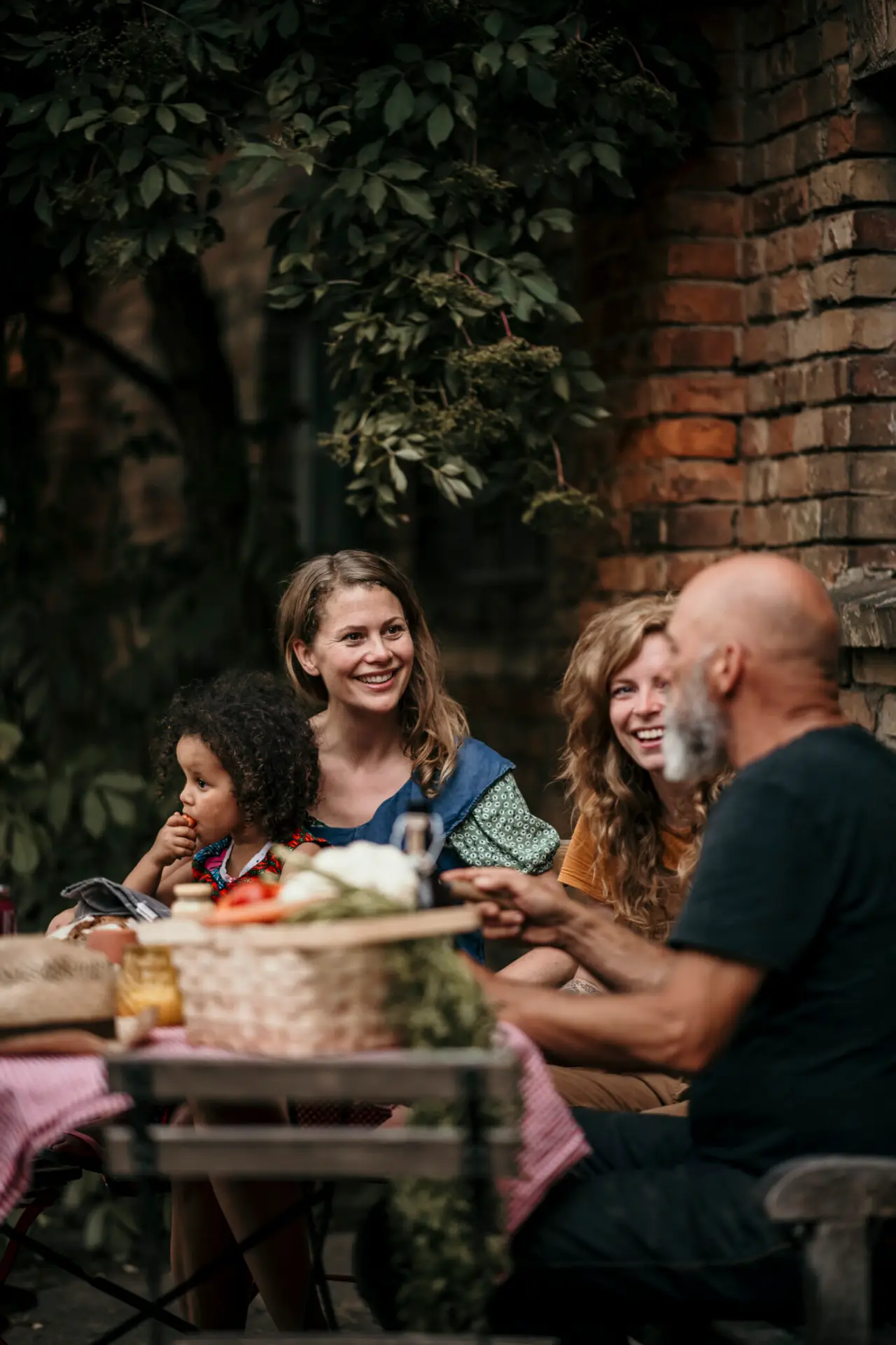 Friends having discussion while sitting at backyard